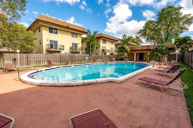 a view of a house with swimming pool and porch