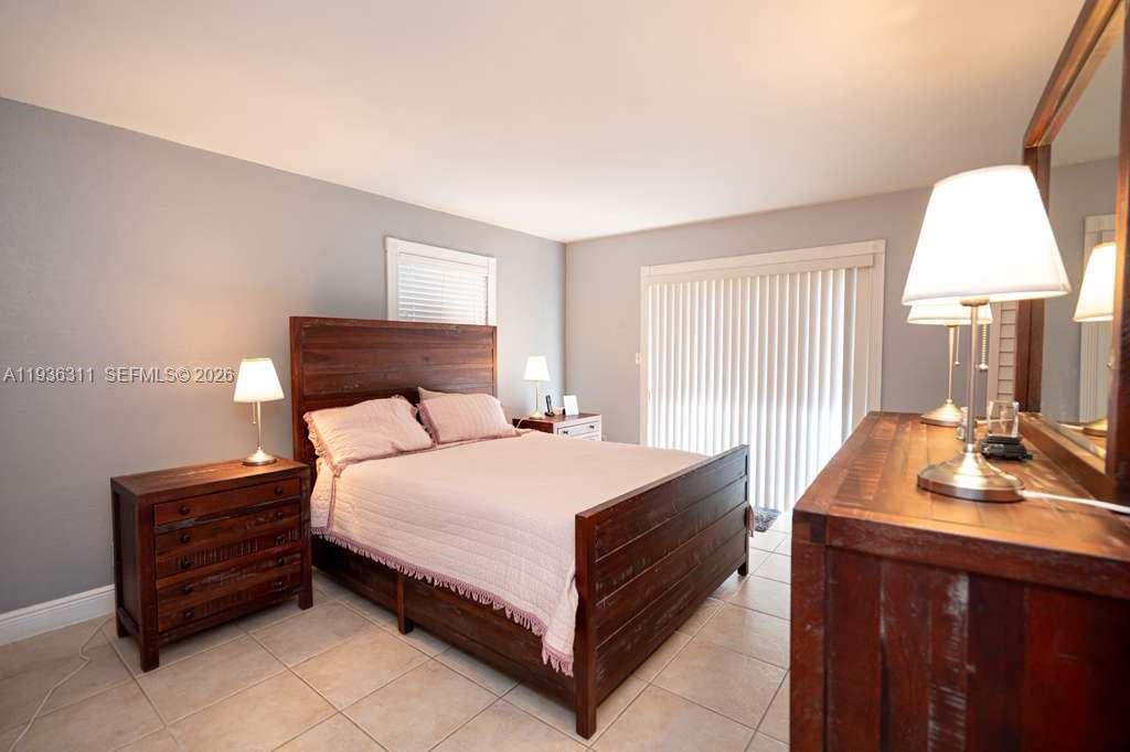 8600 Southwest 109th Avenue, Unit 4114 Miami, FL 33173 - Photo 4 of 44 a bed sitting in a spacious bedroom next to a window