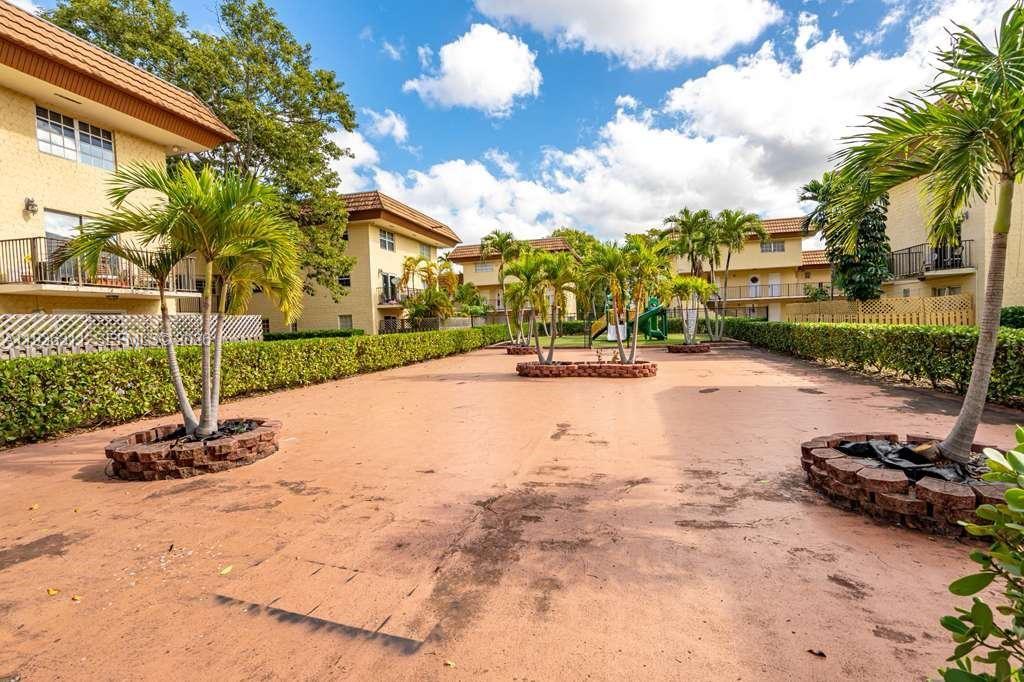 8600 Southwest 109th Avenue, Unit 4114 Miami, FL 33173 - Photo 43 of 44 a view of a street with a building and a big tree
