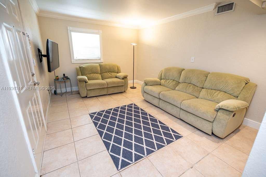 8600 Southwest 109th Avenue, Unit 4114 Miami, FL 33173 - Photo 8 of 44 a living room with furniture a flat screen tv and a window
