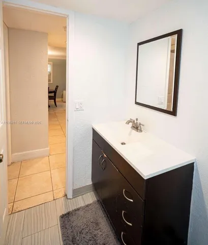 a bathroom with a sink vanity and mirror