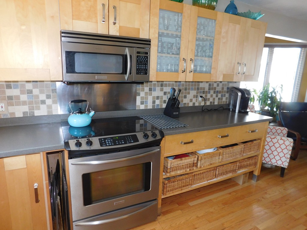 700 Shore Drive, Unit 901 Fall River, MA 02721 - Photo 7 of 19 a kitchen with granite countertop a stove top oven microwave and cabinets