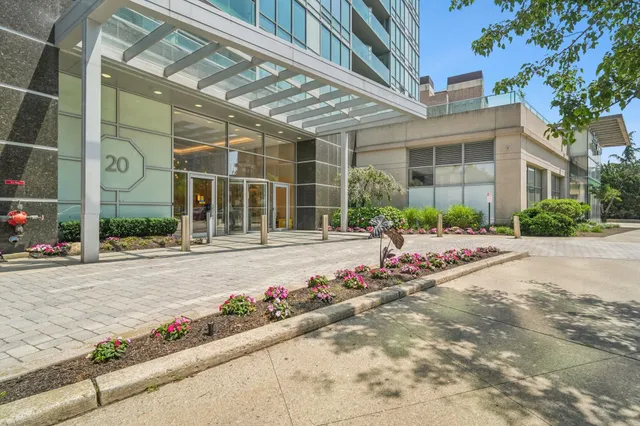 a view of a lake and tall building in the background