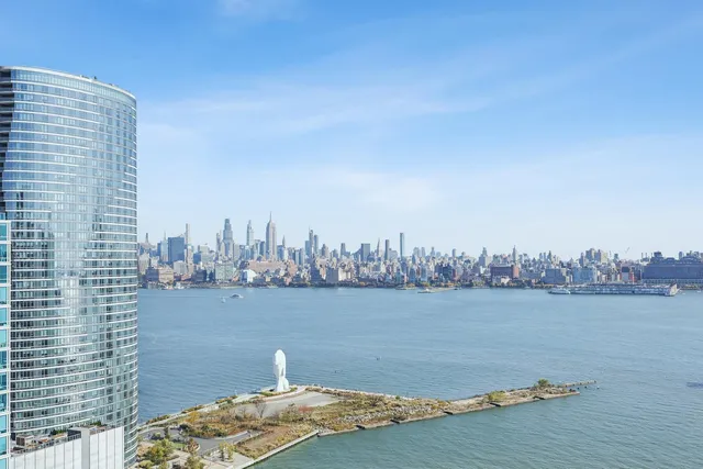 a view of multi story residential apartment building with a yard