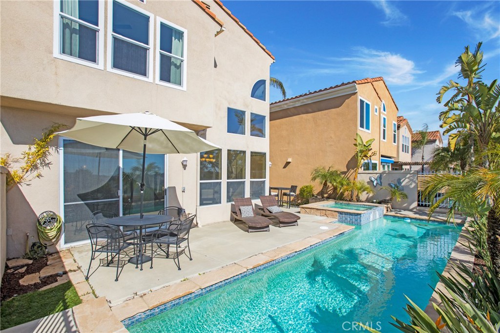 32 Blazewood Lake Forest, CA 92610 - Photo 12 of 41 a view of a patio with couches table and chairs under an umbrella