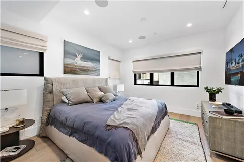 a bedroom with a large bed and a couch