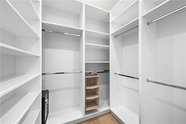 a view of walk in closet with empty racks