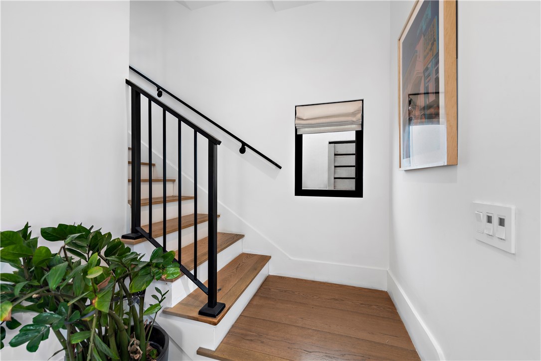616 1/2 Acacia Avenue Corona del Mar, CA 92625 - Photo 4 of 20 a view of a hallway with wooden floor and stairs