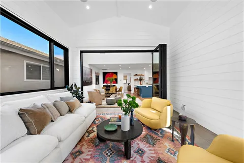 a living room with furniture a rug and a large window