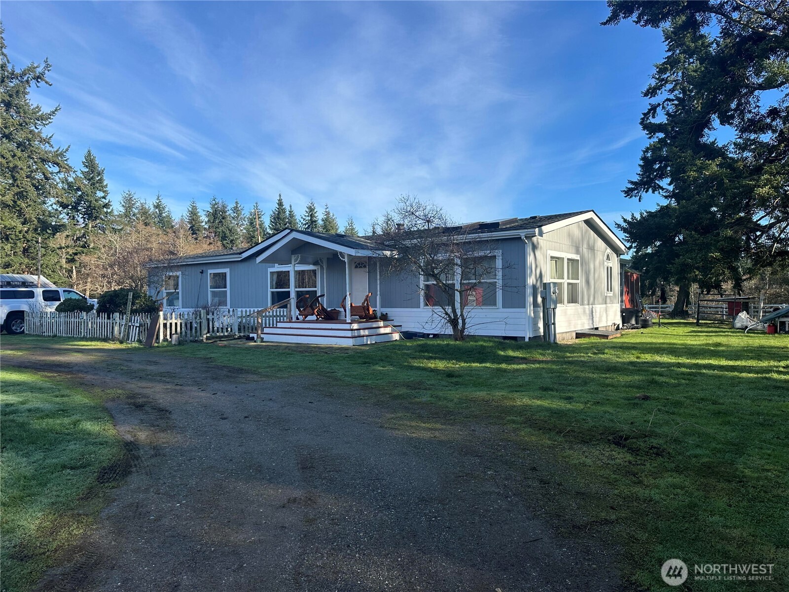 1113 Oakes Road Coupeville, WA 98239 - Photo 1 of 1 a aerial view of a house with a big yard potted plants and large tree