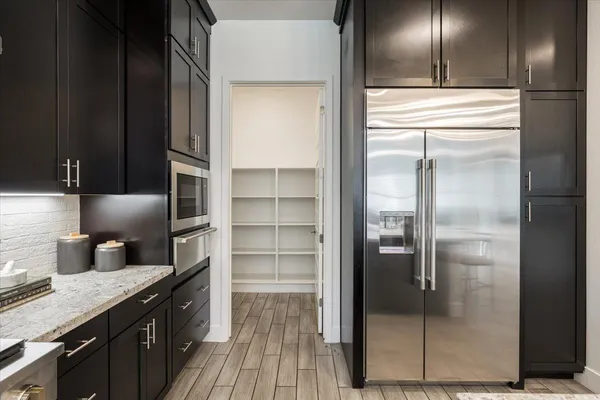a kitchen with stainless steel appliances granite countertop a refrigerator and a sink