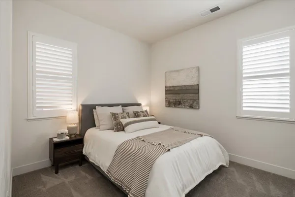 a bathroom with a sink vanity mirror and toilet