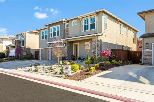 a front view of a house with flowers