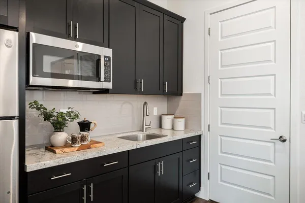 a living room with furniture a flat screen tv and a window