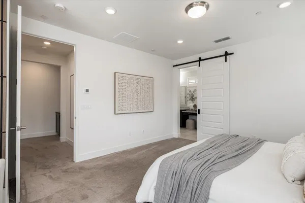 a bathroom with a granite countertop sink a toilet and a mirror