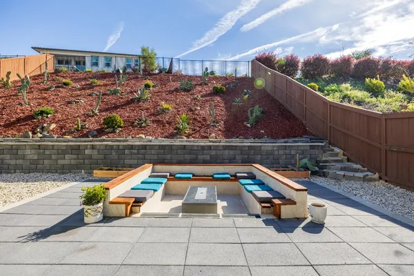 a view of a patio with a table and chairs