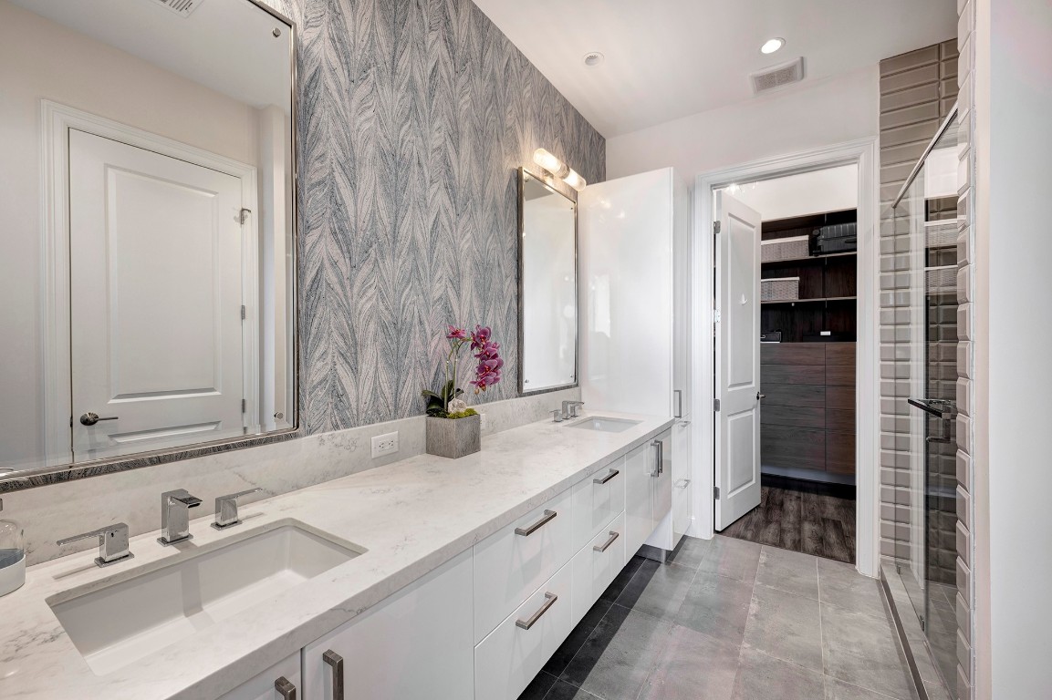 1211 Caroline Street, Unit 1501 Houston, TX 77002 - Photo 12 of 40 Updated primary ensuite bathroom with double sinks and a spacious walk-in closet.
