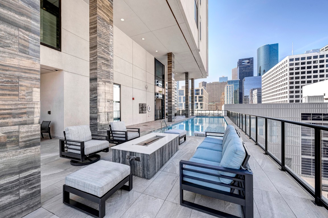1211 Caroline Street, Unit 1501 Houston, TX 77002 - Photo 28 of 40 Terrace pool deck featuring a fire pit and inviting outdoor lounge areas.