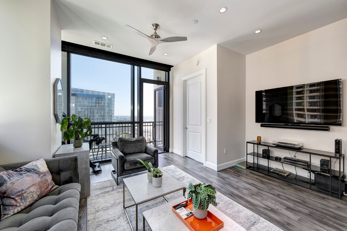1211 Caroline Street, Unit 1501 Houston, TX 77002 - Photo 4 of 40 Additional view of the living room featuring direct access to the private balcony.