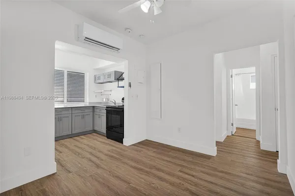a kitchen with a refrigerator and a stove top oven