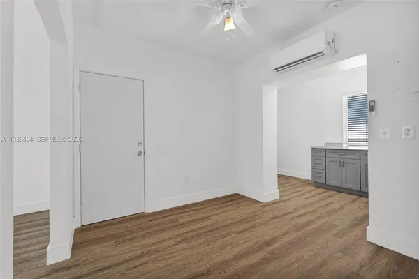 a view of empty room with wooden floor