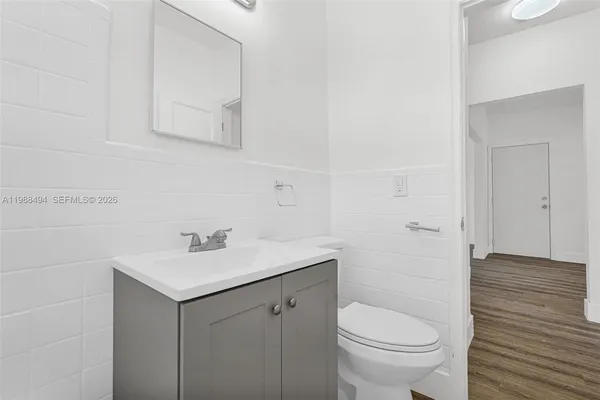 a bathroom with a sink toilet and vanity