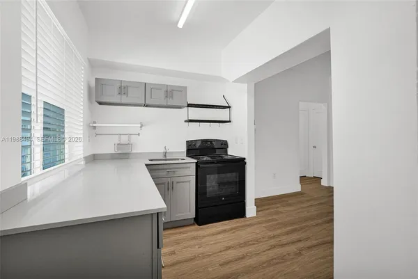 a kitchen with a refrigerator and a stove