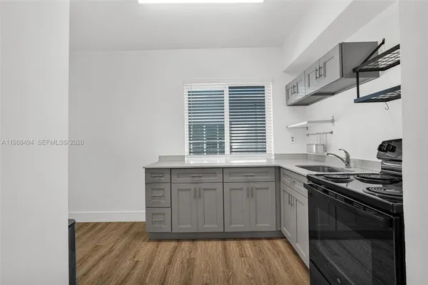 a kitchen with stainless steel appliances granite countertop a stove and a sink