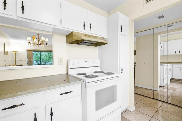a view of kitchen with furniture and a refrigerator