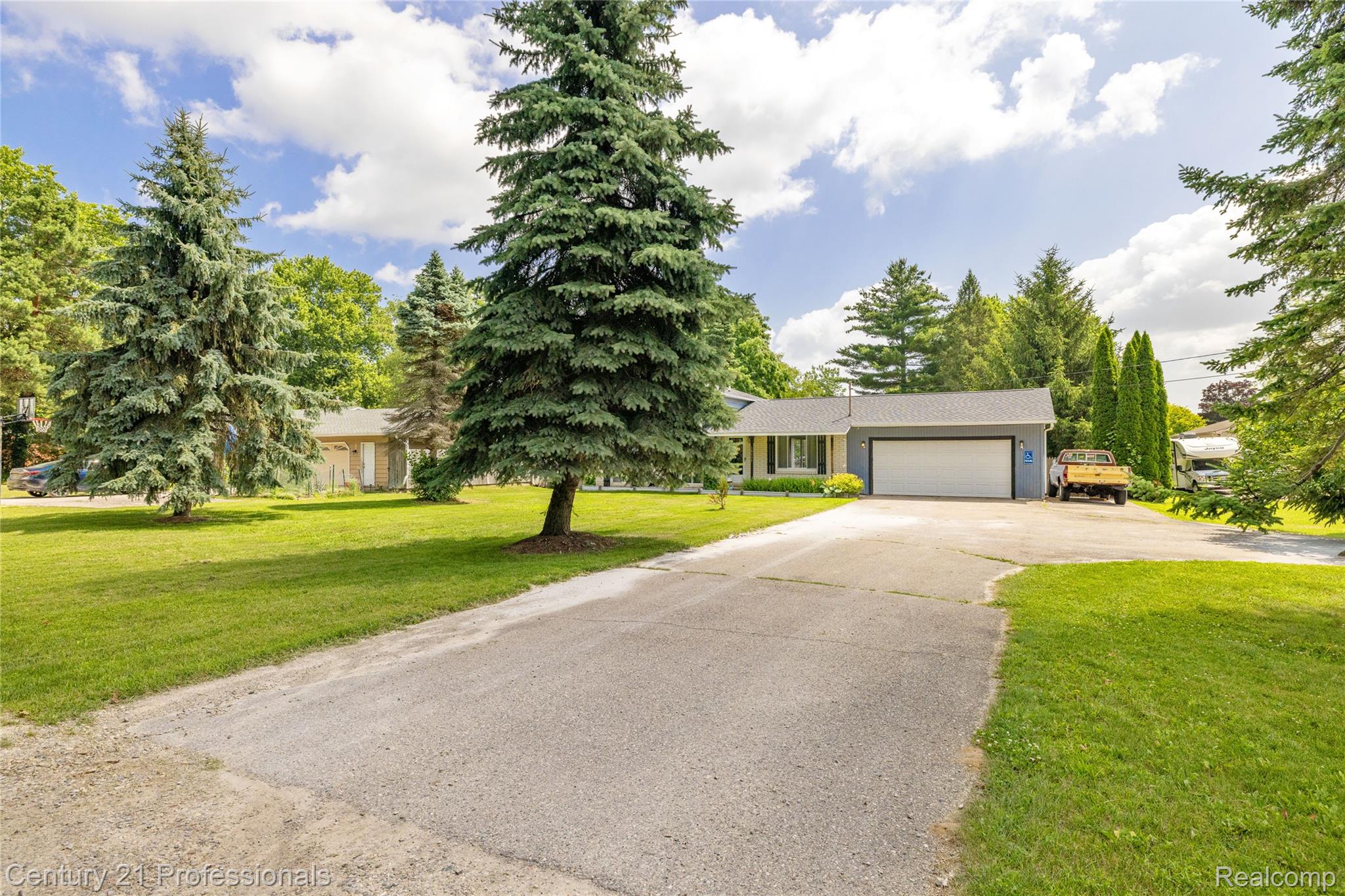 15037 Hogan Road Linden, MI 48451 - Photo 35 of 38 Ranch-style residence featuring a gray exterior and a prominent two-car garage