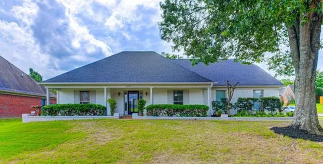 a front view of a house with garden