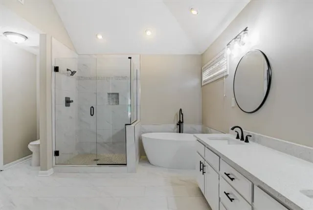 a bathroom with a sink toilet and shower
