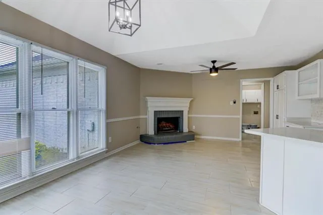 a living room with stainless steel appliances furniture and a fireplace