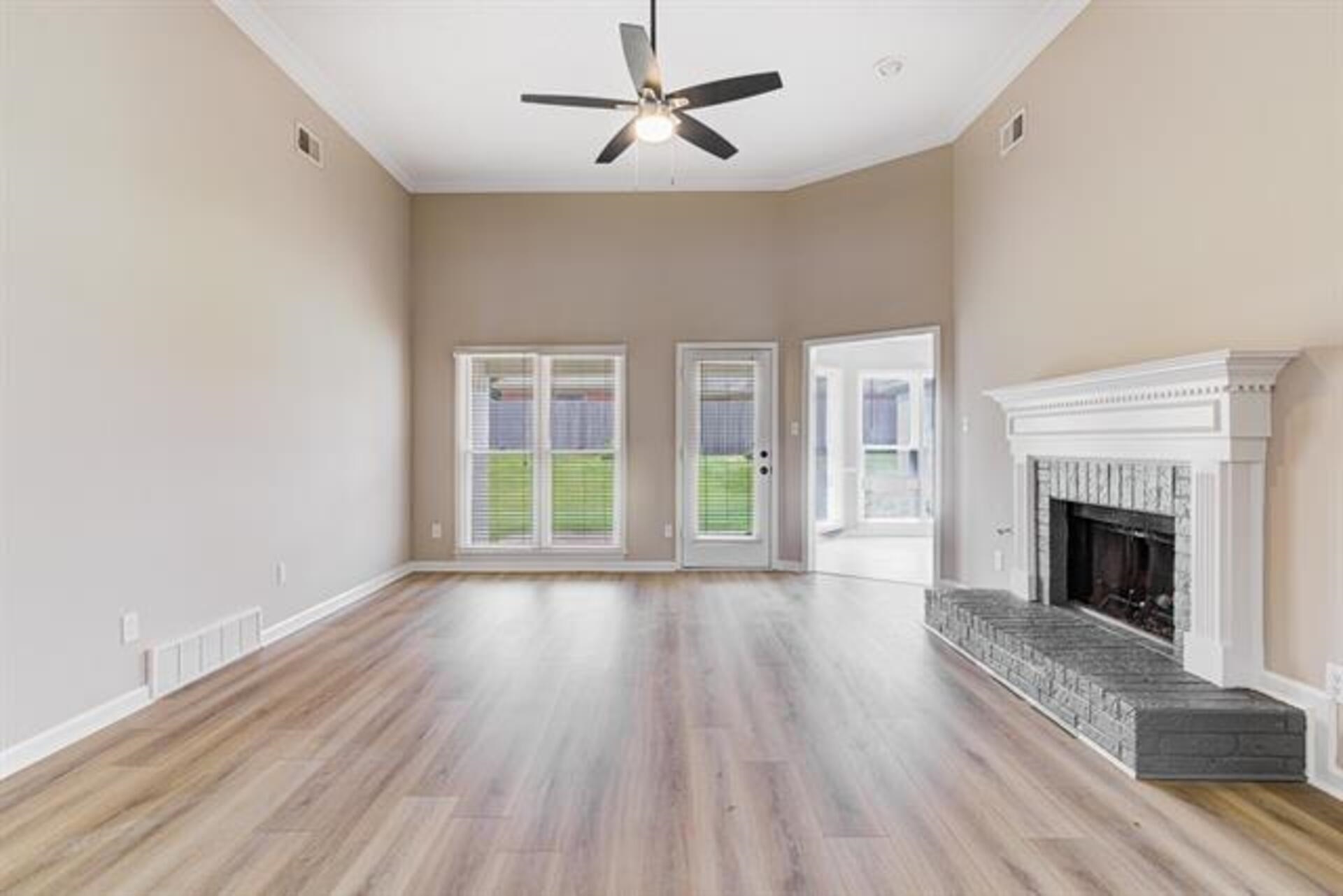 1937 Ada Lane Memphis, TN 38016 - Photo 7 of 28 a view of an empty room with wooden floor fireplace and a window