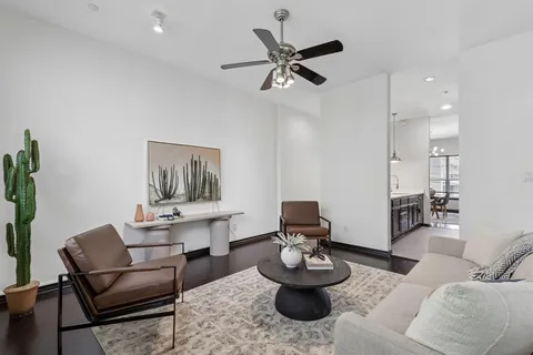 a living room with furniture and a wooden floor