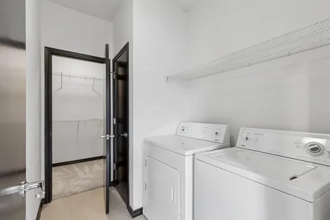 a view of storage and utility room with washer and dryer