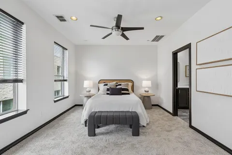 a bedroom with a bed and a refrigerator