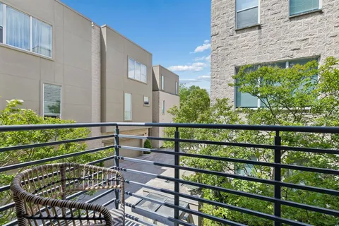 a view of a balcony with wooden floor and bench