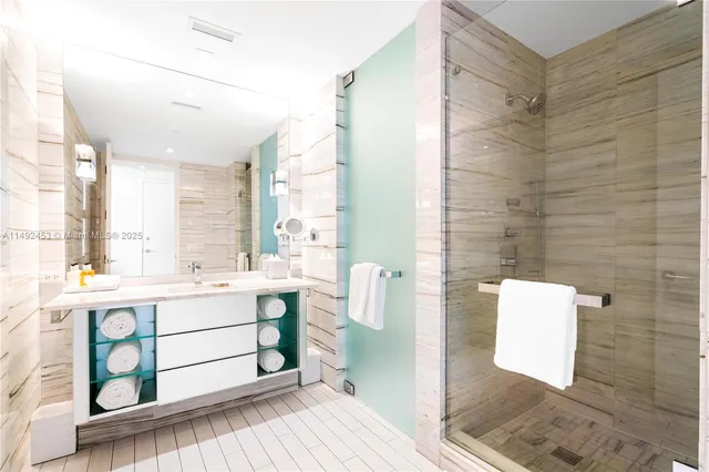a bathroom with a double vanity sink toilet and shower