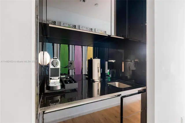 a kitchen with stainless steel appliances granite countertop a sink and cabinets