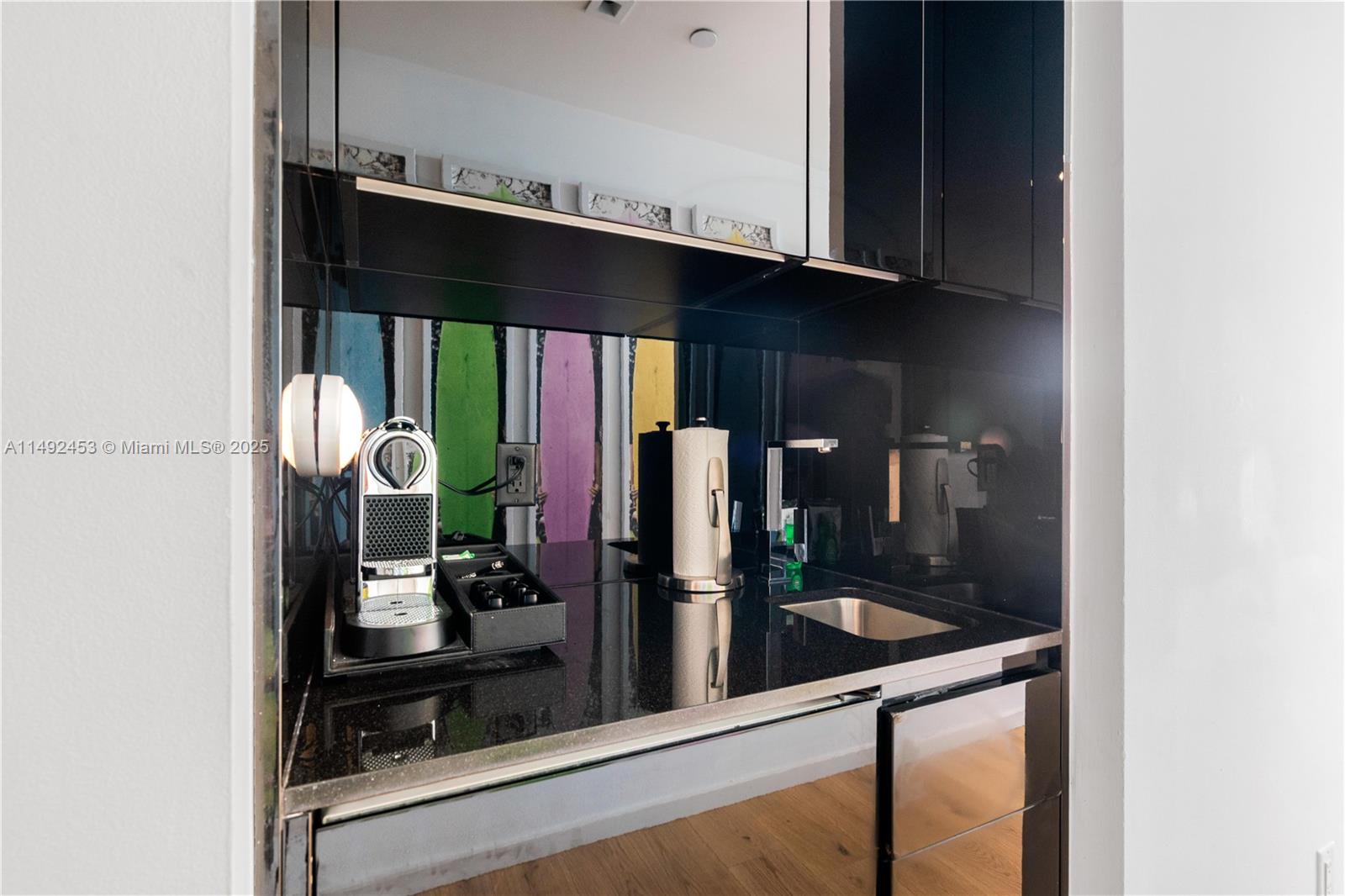 2201 Collins Avenue, Unit 1226 Miami Beach, FL 33139 - Photo 5 of 20 a kitchen with stainless steel appliances granite countertop a sink and cabinets