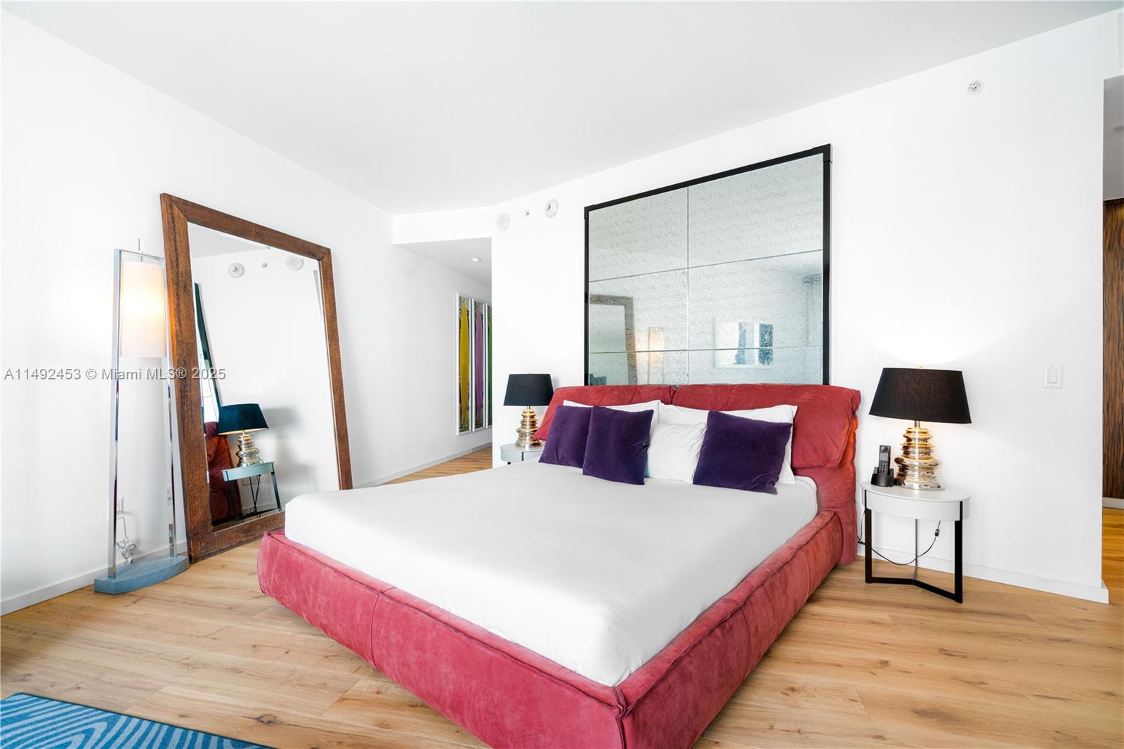 2201 Collins Avenue, Unit 1226 Miami Beach, FL 33139 - Photo 10 of 20 a bedroom with a bed and a large mirror