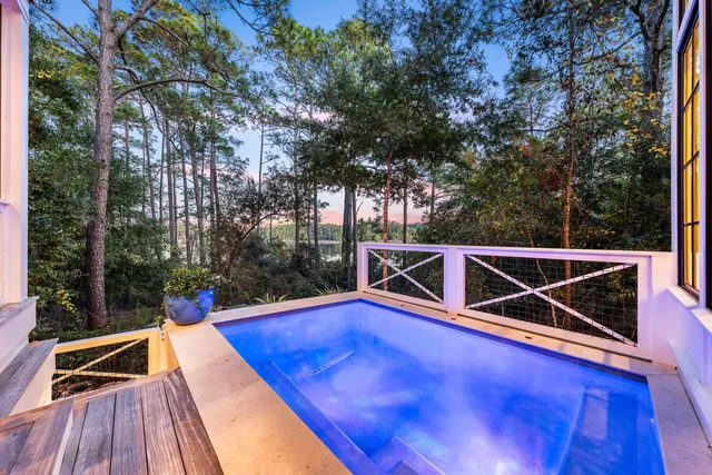 an aerial view of a houses with a yard and lake view