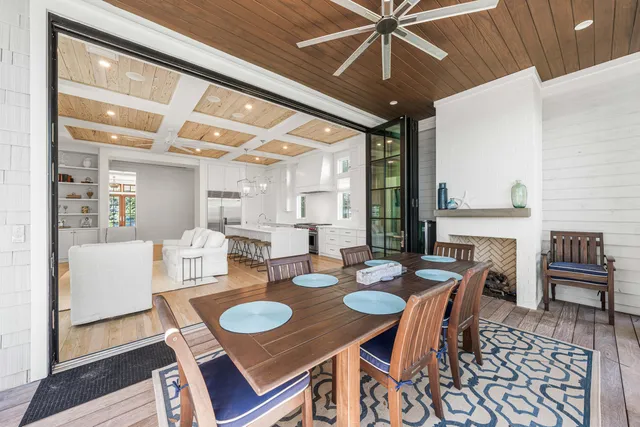 a view of a patio with table and chairs and wooden floor