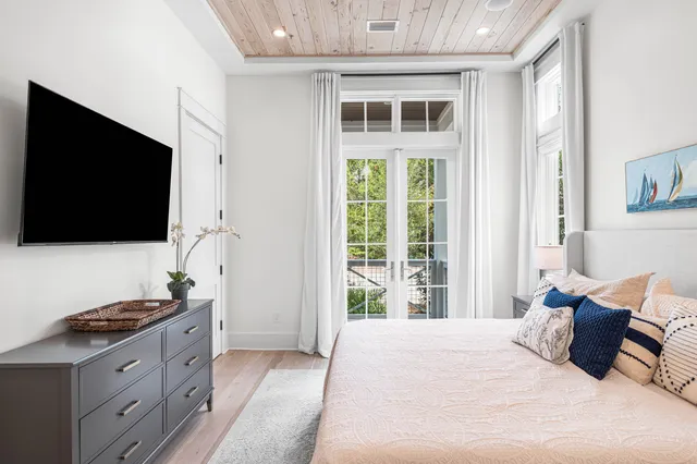 a bedroom with a large bed and a flat screen tv