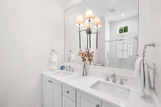 a bedroom with a large bed and a night stand