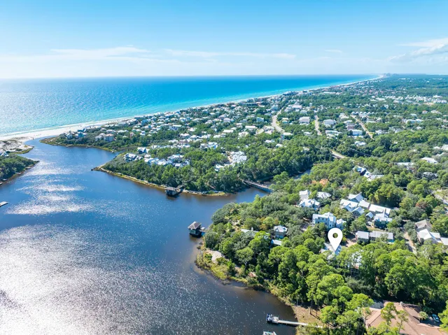 a backyard of a house with lots of green space and fountain