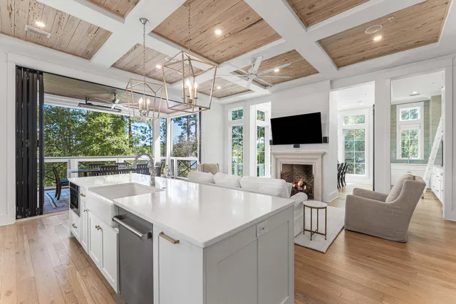 a kitchen with a table chairs and white cabinets