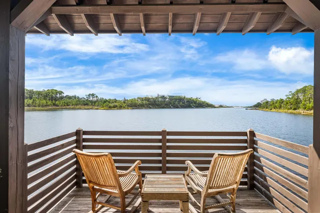 a view of a yard with plants and wooden fence