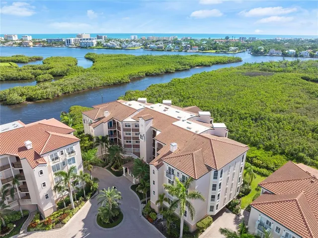 an aerial view of a house with garden space and lake view